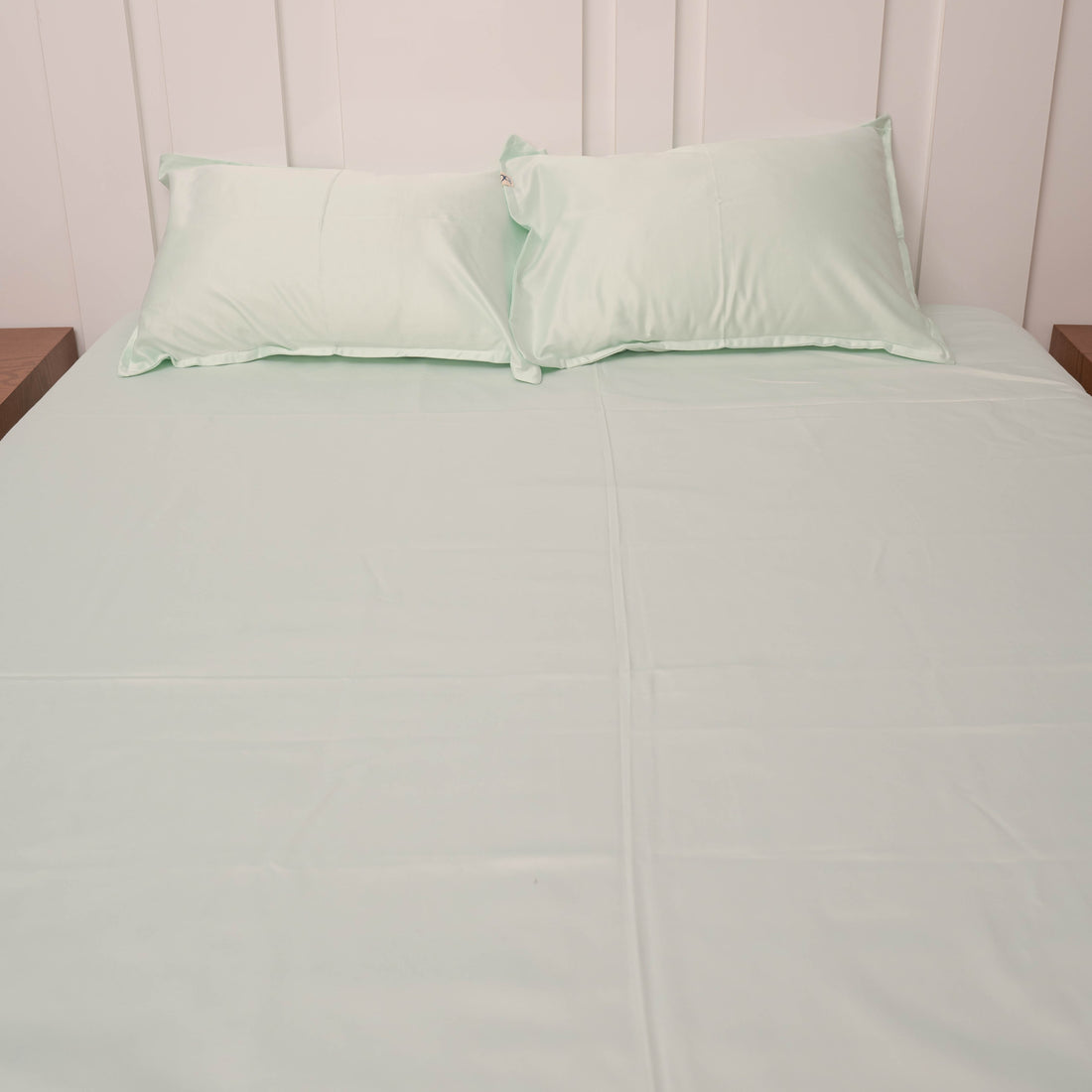 Satin bedsheet styled on king-size bed in bedroom