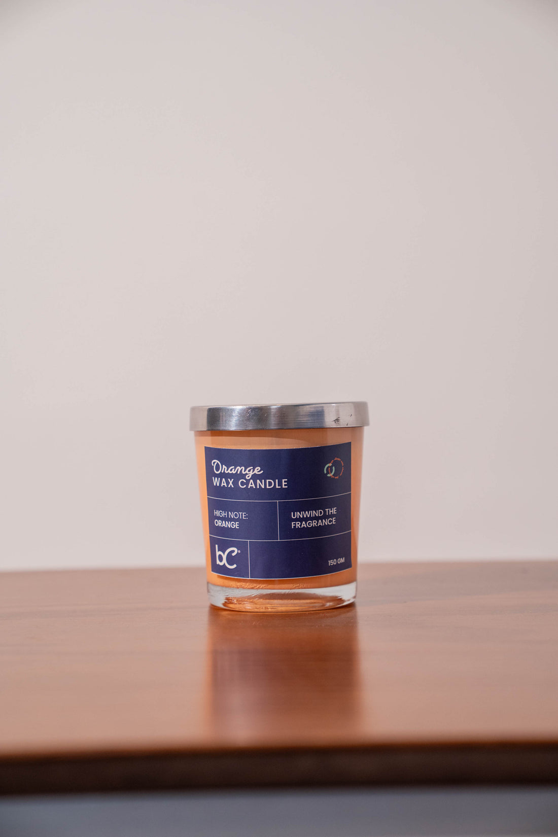 Scented candle lit on bedside table