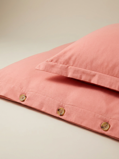 Salmon duvet cover button closure close-up