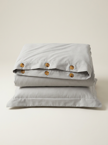 Light gray microfiber duvet cover folded with buttons