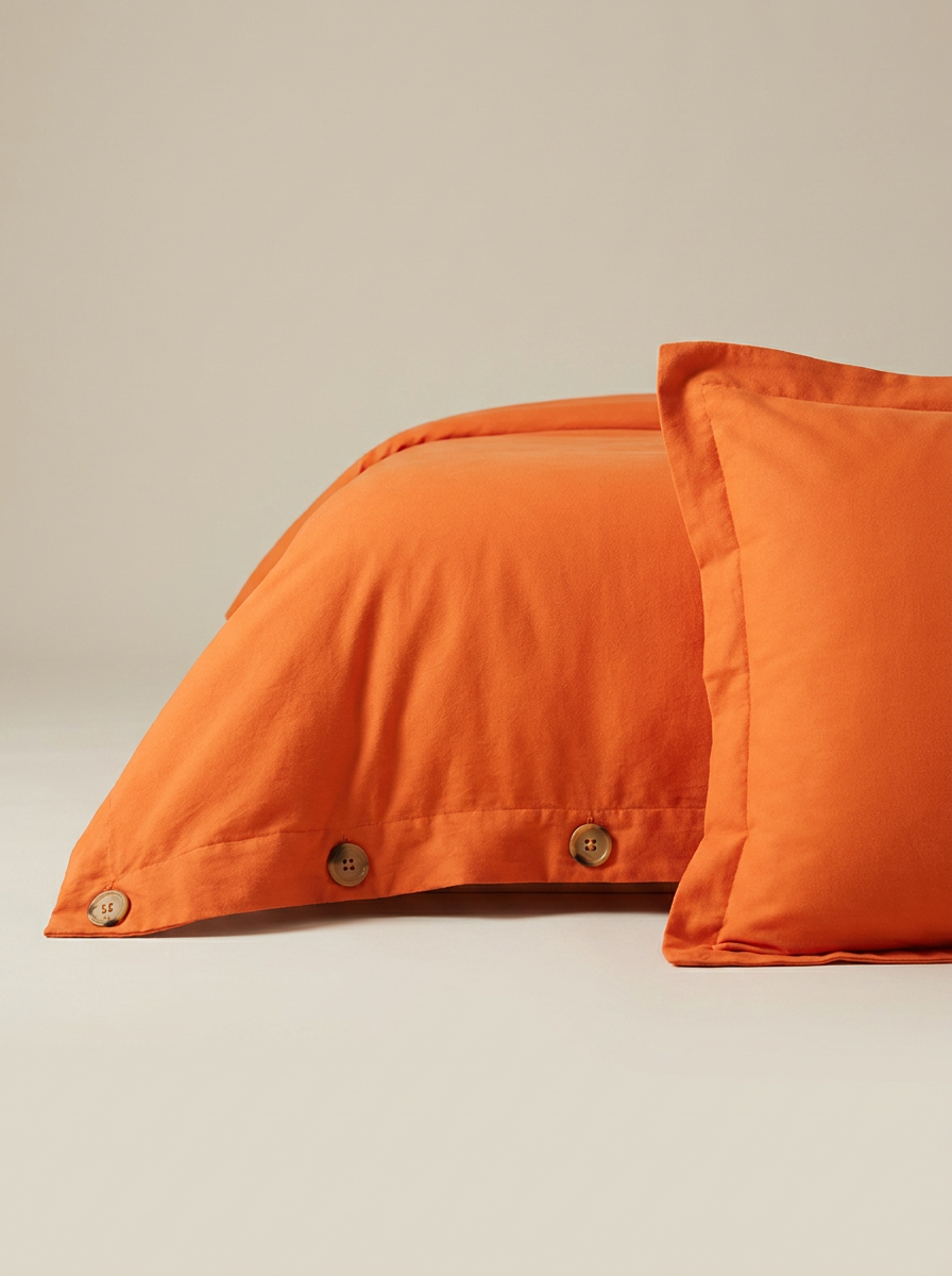 Orange duvet cover button closure close-up